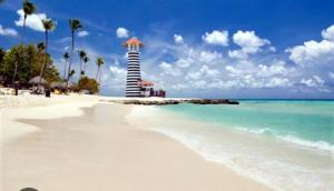 a beach with a lifeguard tower on the beach at las gaviotas in Bayahibe