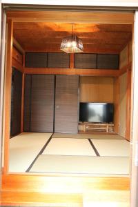a room with a tv and a door with a tvictericter at Bob's house - Vacation STAY 42876v in Kameoka