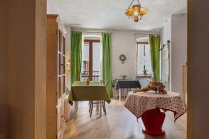 a living room with a table and a dining room at Edelweiss Alp Rooms in Castello Tesino