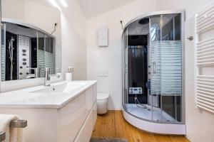 a white bathroom with a shower and a sink at Landhaus Bleckede - App 2 Lüneburg in Bleckede +18 photos