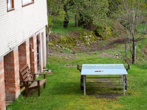 a ping pong table and a bench next to a building at Bühlbauernhof in Bad Peterstal-Griesbach +33 photos