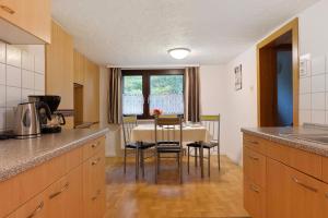 a kitchen with a table and a dining room at Haus an der Landhege in Mainhardt