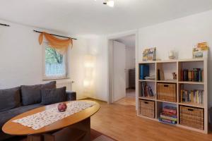 a living room with a couch and a table at Haus an der Landhege in Mainhardt