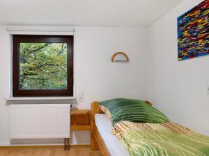 a bedroom with a bed and a window at Haus an der Landhege in Mainhardt