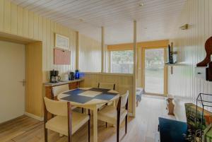 a kitchen and dining room with a table and chairs at La maison de la Rebergère in Javené