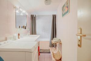 a white bathroom with a sink and a tub at La maison de la Rebergère in Javené +12 photos
