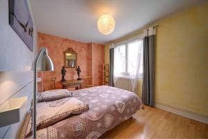 a bedroom with a large bed and a window at Luchon Maison Flor in Luchon