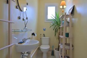 a bathroom with a white sink and a toilet at Luchon Maison Flor in Luchon +16 photos