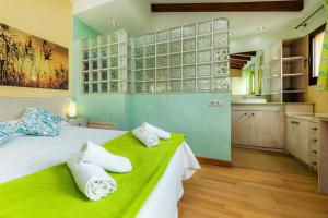 a bedroom with a large bed with towels on it at Can Magraner in Port de Pollensa +21 photos