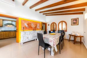 a kitchen and dining room with a table and chairs at Can Magraner in Port de Pollensa