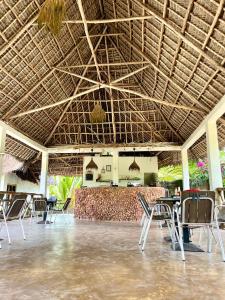 a room with chairs and a bar in a resort at Apartments Maliki, Matemwe in Matemwe