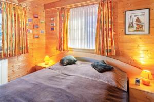 a bedroom with a large bed with two pillows at Emslandstube in Walchum