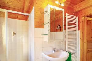 a bathroom with a sink and a mirror at Emslandstube in Walchum +22 photos