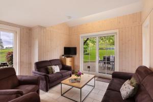 a living room with two couches and a table at Ferienhaus Wasserfall in Bestwig