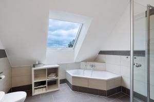 a bathroom with a sink and a window at Ferienhaus Wasserfall in Bestwig +30 photos