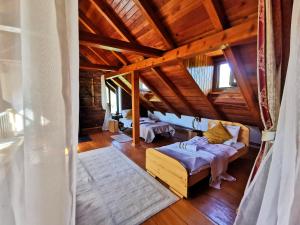 a living room with a couch and a wooden ceiling at Greenwood Cottage house for rent near Zagreb in Pisarovina +173 photos