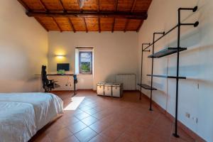 a bedroom with a bed and a desk in a room at Somewhere Over the Hills in Terni