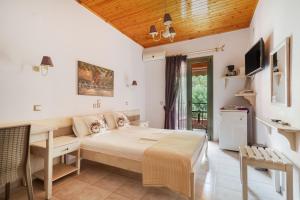 a bedroom with a bed and a table and chairs at Nontas Homes 34 in Kalamitsi