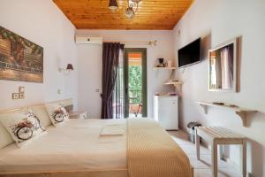 a bedroom with a bed and a television in it at Nontas Homes 34 in Kalamitsi