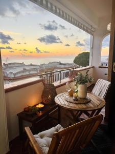 a balcony with a table and a view of the ocean at Brezza Calabra Sea View Apartments in Scalea