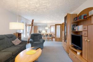 a living room with a couch and a table at Ferienwohnungen Carstensen in Nordstrand