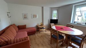 a living room with a couch and a table at Villa Fichteneck in Oberhof