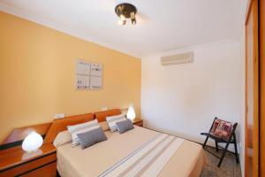 a bedroom with a large bed with yellow walls at Ca Na Cati in Muro +30 photos