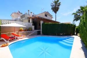 a swimming pool in front of a house at Ca Na Cati in Muro