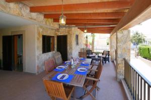 a patio with a long wooden table and chairs at Ca Na Cati in Muro