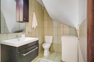 a small bathroom with a sink and a toilet at Villa prolithia 2 in Vlikhón +18 photos