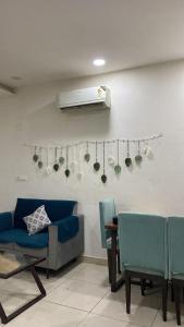 a living room with a couch and chairs and a heater at The Horizon Blue in Zirakpur