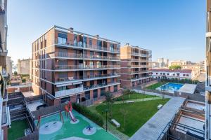 an apartment complex with a playground and a large building at Costa Dorada Perle in Calafell