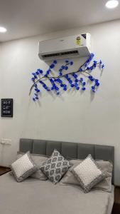 a room with a bed with blue decorations on the wall at The Horizon Blue in Zirakpur