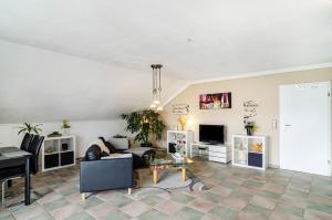 a living room with a couch and a table at Ferienwohnung am Rehwinkel in Fuldatal +30 photos