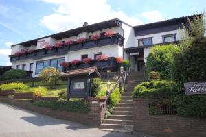 a building with flower boxes on the front of it at Pension Talblick in Höchst im Odenwald