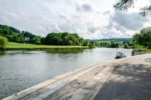 a river with a boat on the side of it at Ferienwohnung am Rehwinkel in Fuldatal