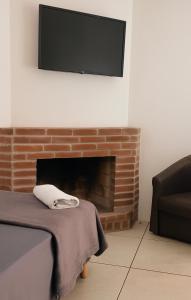 a living room with a tv above a fireplace at hotel fazenda ctk in Santa Cruz do Sul