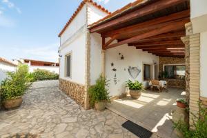 a patio of a house with a wooden pergola at Villa Rita in Flumini di Quartu