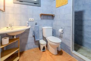 a bathroom with a toilet and a sink at Mas Vinyoles 1 in Montnegre +20 photos