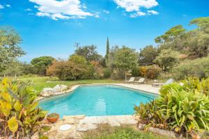 a swimming pool in a yard with plants at Mas Vinyoles 1 in Montnegre