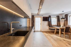 a kitchen with a sink and a counter top at Obermarhof Gsies in Prateria +71 photos