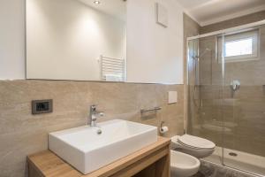 a bathroom with a sink and a toilet and a shower at App. Pedagà - Ciasa Lavarella in San Vigilio Di Marebbe