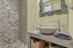 a bathroom with a sink and a mirror at Natura Oliva House in Alikanas +25 photos