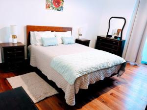 a bedroom with a large bed with two night stands at Garden View Apartment in Horta