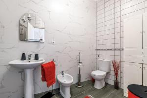 a white bathroom with a sink and a toilet at Garden View Apartment in Horta +22 photos