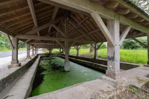 a bridge with a pool of green water under it at Sarzeau centre - Le Cormoran in Sarzeau +13 photos