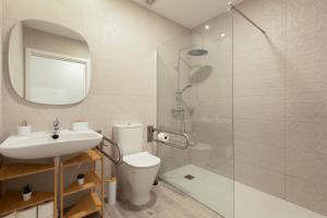 a bathroom with a shower and a toilet and a sink at Apartamento Avenida Marítima in Candelaria +19 photos