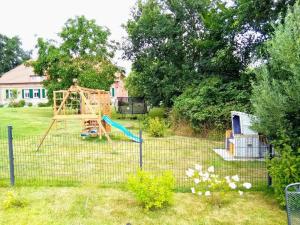 a yard with a playground with a swing at Das Landhaus Wohnung 2 in Kirch Mulsow