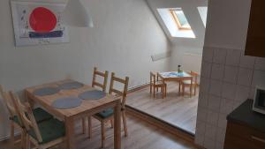 a kitchen and dining room with a table and chairs at Das Landhaus Wohnung 2 in Kirch Mulsow