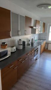 a kitchen with white appliances and brown cabinets at Das Landhaus Wohnung 2 in Kirch Mulsow +15 photos
